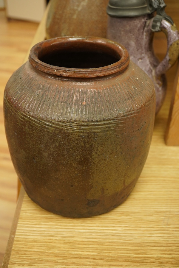 A lead glazed and manganese pewter-mounted ewer, a salt glazed pitcher and a terracotta pot, tallest 35cm